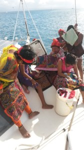 Guna ladies selling molas.  Note that though they agreed to the photo, they mostly hide their faces.