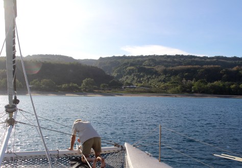 Anchoring in Malua Bay off of the school (big roof) where Bob met many of the kids.