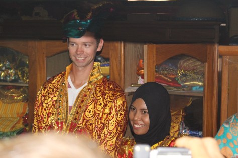 John models traditional wedding garb, with Ulhy as his bride.