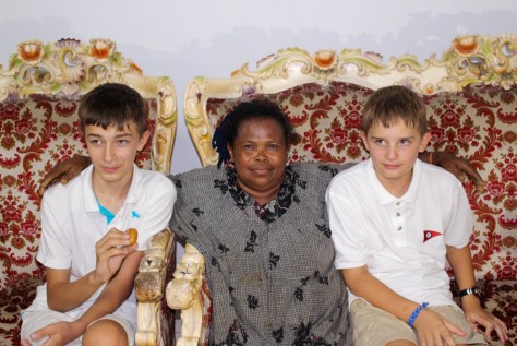 This woman laughs and teases and plops herself down between the boys for a photo. Doesn't matter that she doesn't have a camera; probably a photo will get to her from someone, but that doesn't seem to matter either.