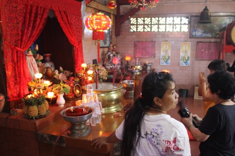 Where your question may be answered; the woman on the right is shaking the container of numbered sticks.