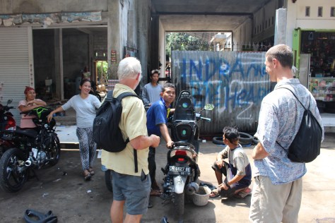 Fixing Tim's motorbike, on our quest to the waterfall