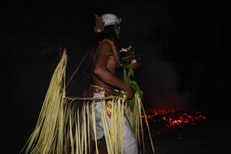 Not only does the God that enters this man's body walk on burning coconut coals...