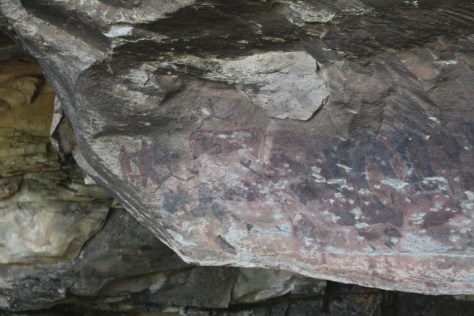 One thing we learn is that this painting was shot at by British solders. The Bushmen then painted two Brit redcoats to the left. This is a Stone Age culture painting "modern" solders 150 years ago!